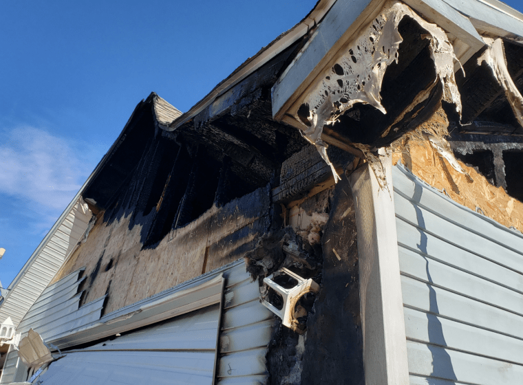 fire damage on a side of a house with light grey sidings